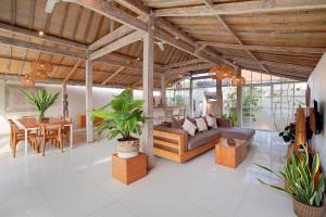 a living room with a couch and a table at Villa Balimasan 10 mins to Canggu in Seminyak