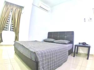 a bedroom with a bed and a table and a window at Arang Homestay14pax 4room(BBQ)(Kbox)Near to Beach in Port Dickson