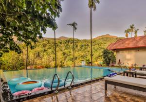 a swimming pool with a view of the mountains at Hill Crest Resort - Coorg in Madikeri