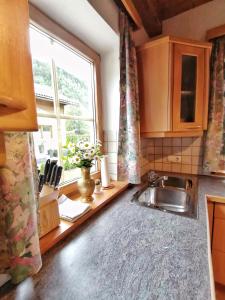 a kitchen with a sink and a window at Sonniges Landhaus in den Hohen Tauern in Rauris