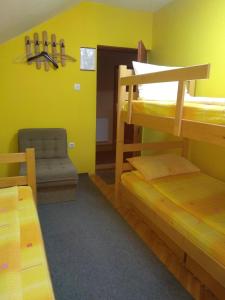 a room with two bunk beds and a chair at Smeštaj - sobe MARVEL in Niš