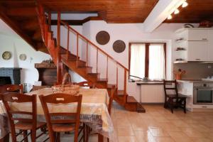 a kitchen and dining room with a table and a staircase at Docker 2 Beachfront Villa Vourvourou by Halkidiki Villas in Vourvourou
