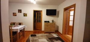 a room with a table and a television on the wall at Apartments in Villa Barbara in Świeradów-Zdrój