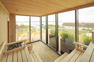a screened in porch with a view of the ocean at Appartements "Zum Leuchtturm" Hafen Rankwitz Insel Usedom in Rankwitz