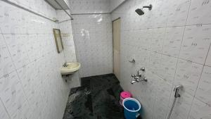 a bathroom with a sink and a toilet at Hotel Plaza Rooms - Prabhadevi Dadar in Mumbai
