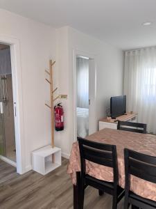 a room with a table and chairs and a television at CASAS DONA EMILIA in Vieira de Leiria