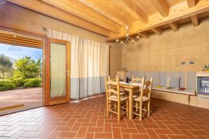 a kitchen with a table and chairs in a room at Domu Bresca in Muravera