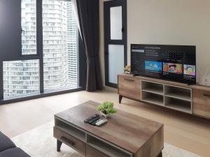 a living room with a tv and a coffee table at Star KLCC by Arman in Kuala Lumpur