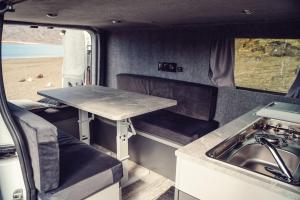a table in the back of an rv with a sink at Rijo campers in Ytri-Njarðvík