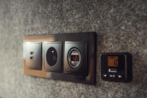 a close up of an electrical outlet with a clock at Rijo campers in Ytri-Njarðvík