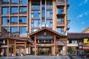 a building with a sign on the front of it at Xiangxi's Love - Yangyun Hotel in Zhangjiajie