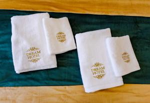 two white towels with the dream hotel on them at Dream Hotel in Haghpat +115 photos