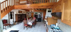 eine Küche und ein Wohnzimmer mit einem Tisch und Stühlen in der Unterkunft Gites Le Grand Jardin in Puydarrieux