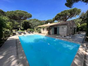 una grande piscina blu di fronte a una casa di Villa La Croix-Valmer, 5 pièces, 8 personnes - FR-1-726-19 a La Croix-Valmer