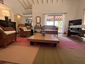 a living room with a table and a piano at Villa La Croix-Valmer, 5 pièces, 8 personnes - FR-1-726-19 in La Croix-Valmer