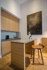 a kitchen with a counter and a chair and a table at The Wellem, in The Unbound Collection by Hyatt in Düsseldorf