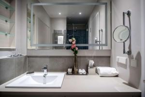 a bathroom with a sink and a mirror at The Wellem, in The Unbound Collection by Hyatt in Düsseldorf