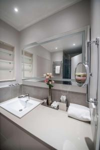 a bathroom with a sink and a mirror at The Wellem, in The Unbound Collection by Hyatt in Düsseldorf