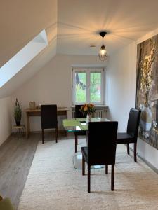 a dining room with a table and chairs at Ferienwohnung 2 in Huglfing im Herzen vom 5 Seen Land Oberbayern in Huglfing