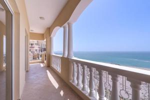 a balcony with a view of the ocean at Relax in Spacious 2BD with Sea View in Al Hamra in Ras al Khaimah