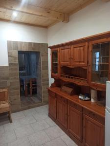 a large kitchen with wooden cabinets and a table at Al Vicoletto in Taranto +8 photos