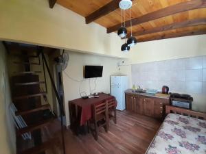 a kitchen with a small table and a refrigerator at Don Orlando in San José