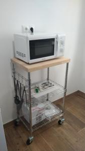 a microwave oven sitting on top of a table at Apartamento Aitue in Gijón