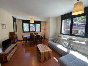 a living room with a couch and a table at Canillo L'Areny View in Canillo