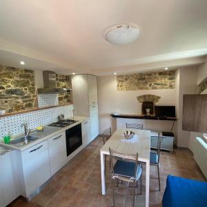 a kitchen with a table and a dining room at Casa Dell'Angelo in Castelnuovo Magra