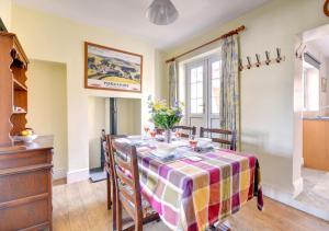 a dining room with a table and chairs at Crossing Keepers Cottage in Grosmont