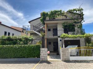 a building with a gate in front of it at Apartments Hrnjić in Umag