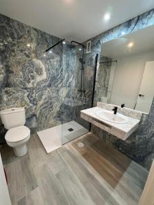 a bathroom with a toilet and a sink at FLEMING PLAYA PONIENTE in Benidorm