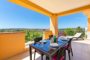 a table and chairs on a balcony with a view at Vale da Ribeira - Casa Serenidade in Mexilhoeira Grande