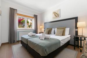 a bedroom with a large bed and a window at Vale da Ribeira - Casa Serenidade in Mexilhoeira Grande +44 photos