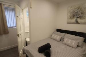a bedroom with a bed with a black towel on it at Stylish one bed apartment with off road parking in Birmingham