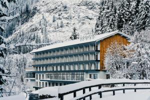 a hotel in the snow with snow covered trees at The Comodo Bad Gastein, a Member of Design Hotels in Bad Gastein