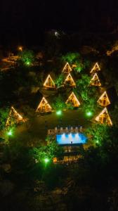 an overhead view of a house with a pool at night at BADEM AĞACI BUGALOWLARI in Kas