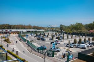 a parking lot with cars parked in a parking lot at Mosella Suite Hotel in Sottomarina