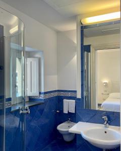 a bathroom with a toilet and a sink and a mirror at Terrazza Duomo in Amalfi
