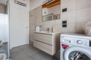 a bathroom with a washing machine and a sink at Casa Flavia, Mountains & River in Arco