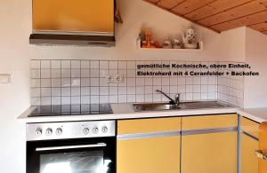 a kitchen with a sink and a stove at Ferienhaus hoch oben mit Alpen Panorama Königssee- Nichtraucherdomizil in Berchtesgaden
