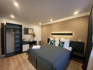 a bedroom with a large bed and a desk at Vila LEMAR wellness & spa in Huncovce