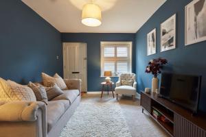 a living room with a couch and a tv at 51 Risbygate Street Bury St Edmunds in Bury Saint Edmunds