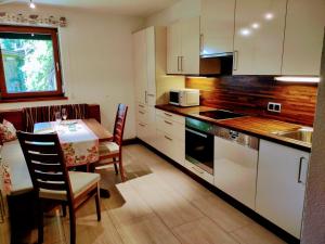 a kitchen with a table and a dining room at Ferienwohnung Familie Fiechtl in Fügenberg +147 photos
