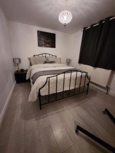 a bedroom with a bed and a chandelier at Private Room in Ilford