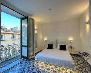 a bedroom with a bed and a large window at Terrazza Duomo in Amalfi