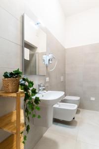 a white bathroom with a sink and a toilet at Residenza Leoncino in Verona