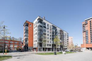 an apartment building on a street in a city at 2ndhomes Tampere "Espa" Apartment - New Apt, Sunset View and Own Sauna near City Center & Finlayson Area in Tampere