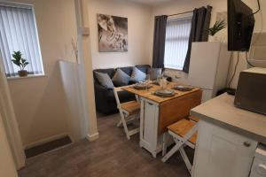 a small kitchen and living room with a small table at Cosy two bedroom first floor apartment in Birmingham