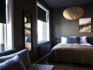 a bedroom with a bed and a large window at Rey Apartments in Reykjavík